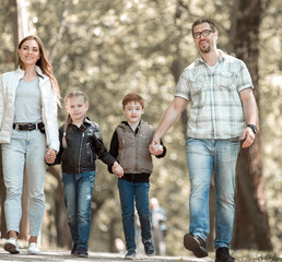 family with two children on a walk in the Park.