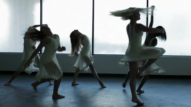 Dance school girls barefoot and in silhouette freestyle dancing