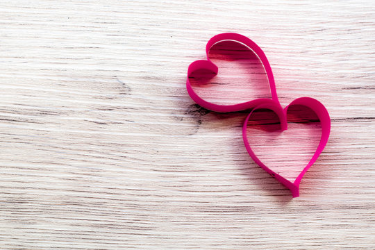 Pink heart made of paper,placed on wooden floor,Valentine's Day concept