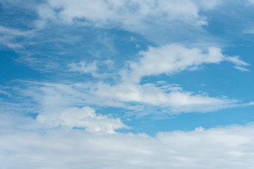 Blue sky background, viewed from an airplane window.