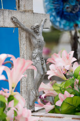 A crucifix is surrounded by decoration of flowers for the Day of the Dead in Mexico.