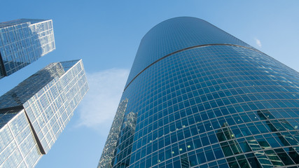 Fototapeta na wymiar Glass windows of skyscrapers against the blue sky