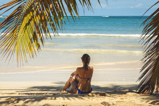 Girl relaxing on tropical beach in Las Galeras, Dominican Republic.