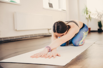 Fototapeta na wymiar Woman doing yoga exercise and fitness at studio class