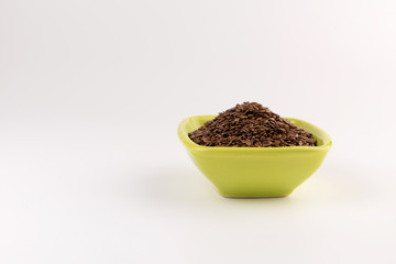 flax seeds in bowl on table background