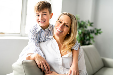 A people and family happy boy with mother on sofa at home