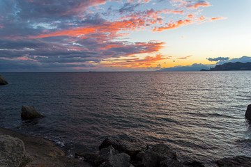 Clouds over the sea illuminated by the setting sun.