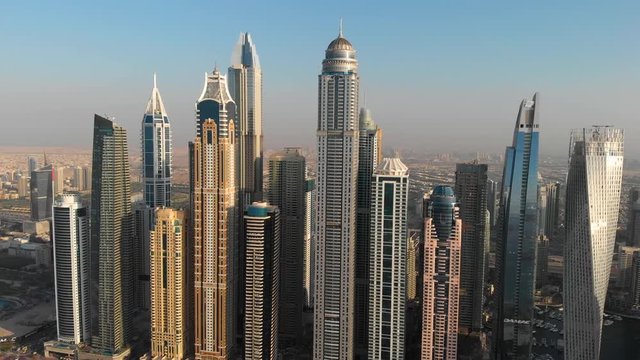Closeup of skyscrapers of Dubai Marina district against the blue sky.