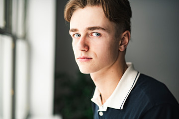 A young teen handsome man portrait at home