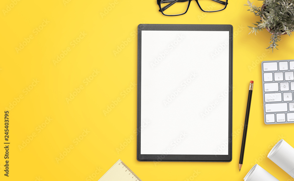 Aufkleber blank paper on folder on yellow office desk with copy space beside. hero, header image, top view, fl
