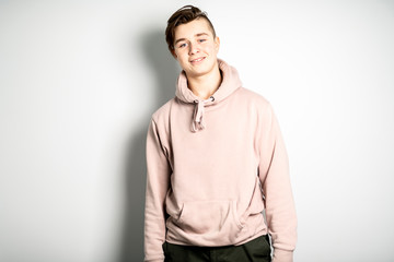 A portrait of young teenager over white wall