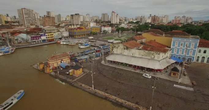 Wide aerial approaching the clock tower and square at the centre of the old port town of Belem do Para in the Brazilian Amazon