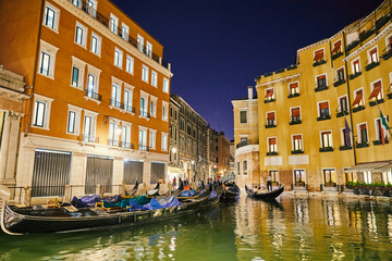 Fototapeta na wymiar Night cityscape of Venice city colorful buildings on water