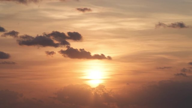 Colorful yellow orange sunrise sky in Islamorada, Florida Keys on gulf of Mexico with sun and clouds moving slow