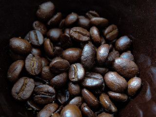Coffee beans close-up in brown Cup. Macrophotography