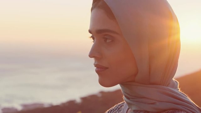 portrait of beautiful muslim woman looking contemplative exploring spirituality feeling peaceful enjoying sunset wearing hijab headscarf