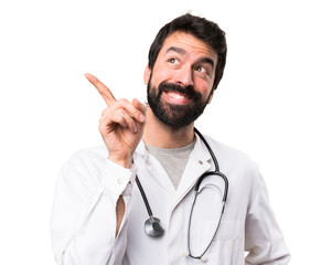 Young doctor thinking on white background