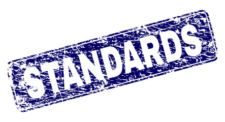 STANDARDS stamp seal print with grunge texture. Seal shape is a rounded rectangle with frame. Blue vector rubber print of STANDARDS caption with dust texture.