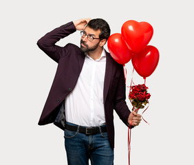 Man in valentine day having doubts while scratching head over isolated grey background