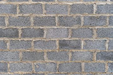 Gray brick wall build construction background. Concrete cinder block brickwall wallpaper.