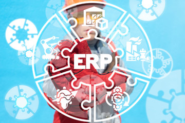 Industry worker working on a virtual screen of the future and sees the abbreviation: ERP. Erp enterprise resources planning industrial concept.