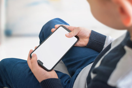 Phone Mockup In Horizontal Position In Kid Hands. Play Game Concept For App Presentation.