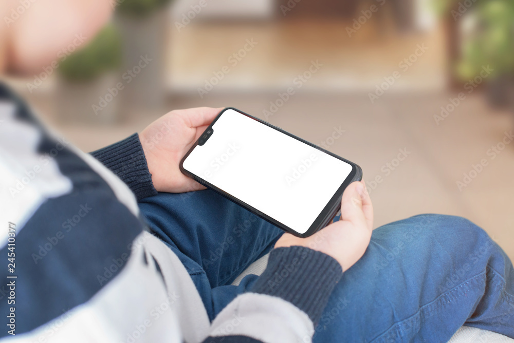 Poster smart phone ih horizontal position in kid hands with blank screen for mockup.