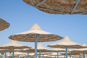 Many beach umbrella from wicker in the sky, Egypt