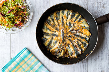 Fresh Fried Sardines / Anchovy Hamsi Tava in Pan on Wooden Surface.