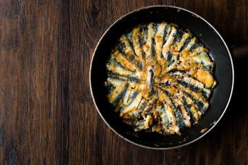 Fresh Fried Sardines / Anchovy Hamsi Tava in Pan on Wooden Surface.