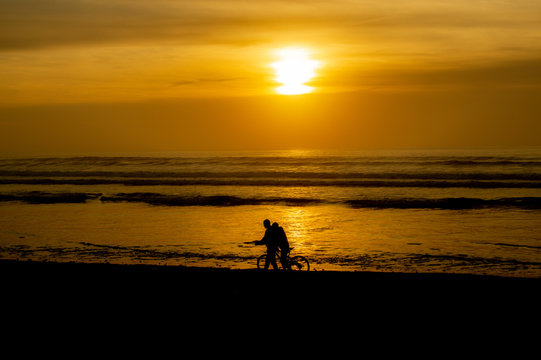 Sunset over main beach in Agadir Morocco showing silhouettes and reflections