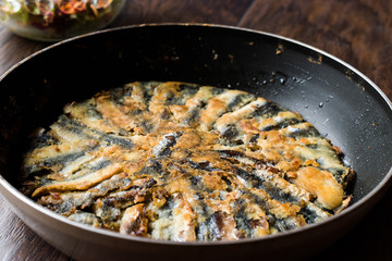 Fresh Fried Sardines / Anchovy Hamsi Tava in Pan on Wooden Surface.