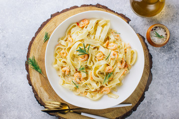 Italian pasta tagliatelle in a creamy sauce with shrimp