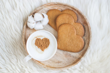 Cappuccino with heart pattern of cinnamon, cookies, cotton dried flowers, Valentine's Day