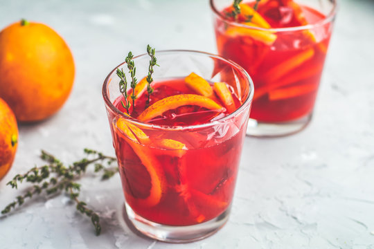 Blood orange margarita cocktail with ice and thyme