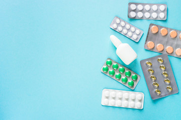 Pills on blue background top view. 