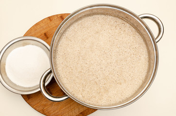 Dough in a metal pan on the table