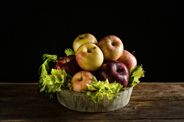 assorted apples in the wooden bowl