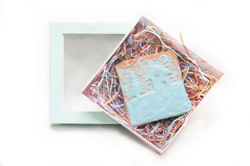 a gingerbread with painted winter landscape in a light blue box