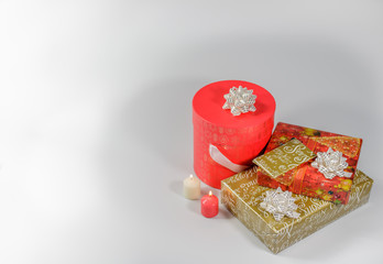 Christmas gifts, nicely packed with elegant colour paper, close up , white background.