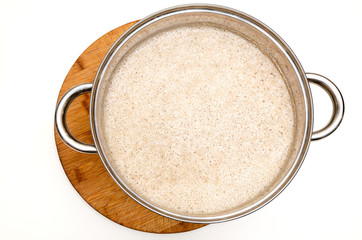 Dough in a metal pan on the table