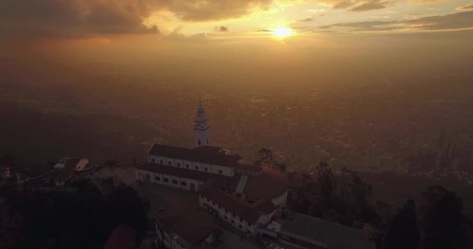Sunset aerial flying over Monserrate Church in Bogota Colombia with the city below