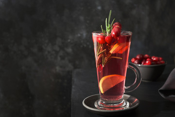 Cranberries cocktail garnish rosemary leaf on black.