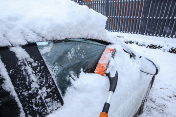 Krasnodar, Russia-December 26, 2018. Brush the snow from the car. Extreme snowfall in european city