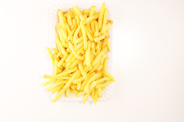 Tasty french fries on table background