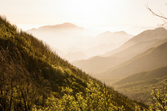 Dramatic mountain valley at sunset with ridges and layers