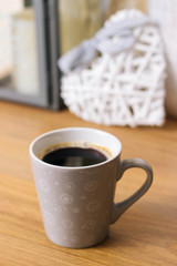 Black coffee with heart in background