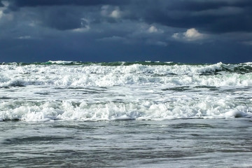 Fototapeta premium Autumn storm. Waves & foam under dramatic sky
