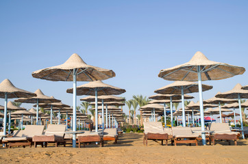 Many beach umbrella from wicker and lounge Hurgada, Egypt