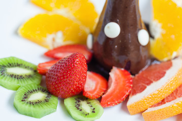 Pear with chocolate sauce at the plate and fruits.Restaurant portion , white background